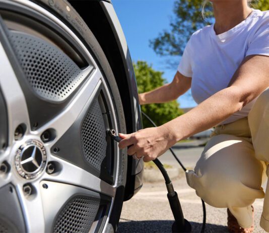 Air-serv sees increase in tyre inflation checks across UK A woman inflates her tyre at a forecourt station.