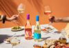 Campo Viejo introduces lighter Contemporary wine range A table dinner is set with different foods and bottles of Campo Viejo Contemporary Rosa and Blanco variants.