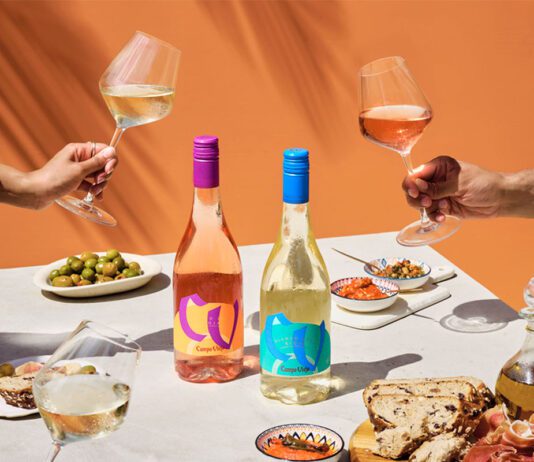 Campo Viejo introduces lighter Contemporary wine range A table dinner is set with different foods and bottles of Campo Viejo Contemporary Rosa and Blanco variants.