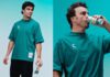 Celsius revs up partnership with Formula One Lance Stroll and Fernando Alonso stand holding cans of Celsius energy drink.