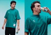 Celsius revs up partnership with Formula One Lance Stroll and Fernando Alonso stand holding cans of Celsius energy drink.