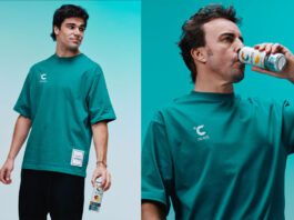 Celsius revs up partnership with Formula One Lance Stroll and Fernando Alonso stand holding cans of Celsius energy drink.