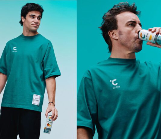 Celsius revs up partnership with Formula One Lance Stroll and Fernando Alonso stand holding cans of Celsius energy drink.