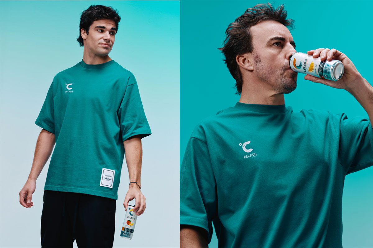 Lance Stroll and Fernando Alonso stand holding cans of Celsius energy drink.