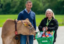 Graham’s Dairy lands new listings in Asda stores Robert Graham, managing director at Graham's The Family Dairy, stands next to Keira McTaggart, community champion at Asda Alloa, stand together as Robert has a cow next to him and Keira holds an Asda basket.