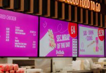 Henderson Technology reaches installation milestone Digital screens inside a convenience store highlighting a food-to-go section from Henderson Technology.