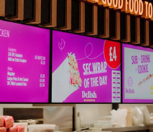 Henderson Technology reaches installation milestone Digital screens inside a convenience store highlighting a food-to-go section from Henderson Technology.