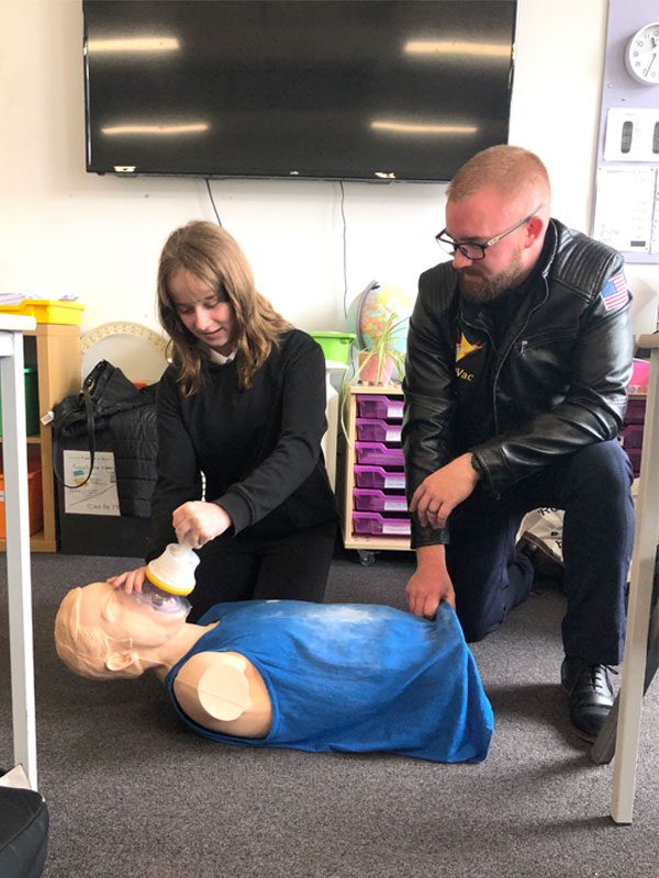 Matt Banagan, co-founder of LifeVac Europe, teaches a child how to use a LifeVac device.