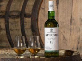 Laphroaig brings back 15 Year Old whisky expression A bottle of Laphroaig 15 Year Old sits on a whisky barrel with two nosing glasses next to the bottle.
