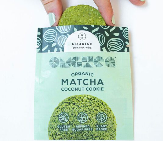 Nourish unveils new Matcha Coconut Cookies A person pulls a Nourish Matcha Coconut Cookie out form its packet.