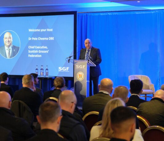 SGF highlights pressure on retailers at Mini Summit Pete Cheema, chief executive at the Scottish Grocers' Federation, delivers a talk from a podium during the SGF Mini Summit 2026.