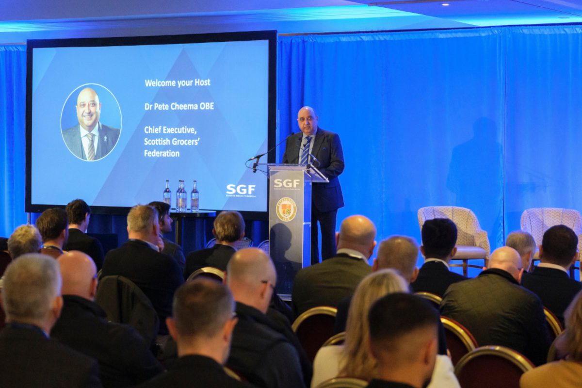 Pete Cheema, chief executive at the Scottish Grocers' Federation, delivers a talk from a podium during the SGF Mini Summit 2026.