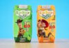 Radnor Hills unveils new Toy Story 5 collaboration Packs of Radnor Hills Toy Story 5 collaboration in Apple and Orange flavours, these are set against a blue background on top of a wooden table.