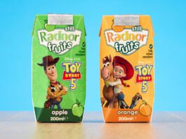 Radnor Hills unveils new Toy Story 5 collaboration Packs of Radnor Hills Toy Story 5 collaboration in Apple and Orange flavours, these are set against a blue background on top of a wooden table.