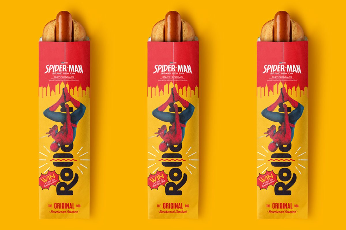 Packs of Rollover Original Hotdog with the Spider-Man: Brand New Day promotion across them are set against a yellow background.