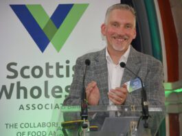 Scottish Wholesale Association highlights sector’s resilience Colin Smith, chief executive at the Scottish Wholesale Association, stands at a podium for the firm's annual conference 2026.
