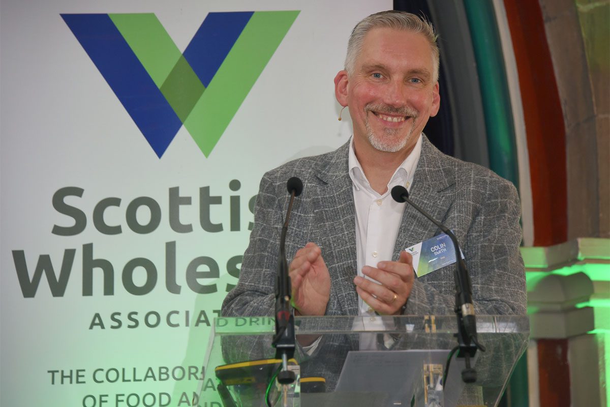 Colin Smith, chief executive at the Scottish Wholesale Association, stands at a podium for the firm's annual conference 2026.