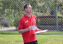 Andy Murray steps into coach role in Walker’s Shortbread campaign Andy Murray stands in a tennis court holding a mug that says 'Walkers Spectator Coach' on it.