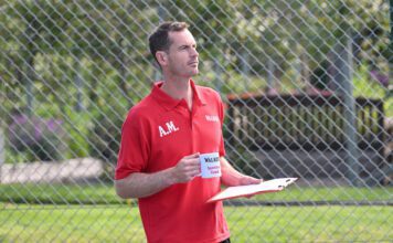 Andy Murray steps into coach role in Walker’s Shortbread campaign Andy Murray stands in a tennis court holding a mug that says 'Walkers Spectator Coach' on it.