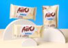 Nestlé unveils new Aero Milkybar range Packs of Aero Milkybar and Aero Milkybar Buttons are stacked on semi-circle shapes against a blue background with a white table.