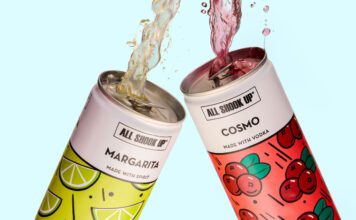 All Shook Up launches new cocktail cans Cans of All Shook Up Margarita and Cosmo are clinked together as the cocktails spill out the top of the cans against a blue background.