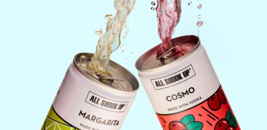 All Shook Up launches new cocktail cans Cans of All Shook Up Margarita and Cosmo are clinked together as the cocktails spill out the top of the cans against a blue background.