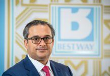 Bestway Wholesale announces new managing director Dawood Pervez, chairman of Bestway Limited, stands in front of the Bestway logo.