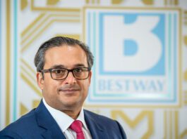 Bestway Wholesale announces new managing director Dawood Pervez, chairman of Bestway Limited, stands in front of the Bestway logo.