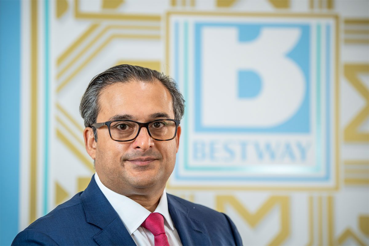 Dawood Pervez, chairman of Bestway Limited, stands in front of the Bestway logo.