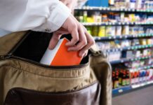Facetime to launch real-time police alert capability A person stealing an item from a store shelf and placing it inside their bag.