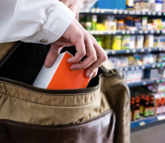 Facetime to launch real-time police alert capability A person stealing an item from a store shelf and placing it inside their bag.