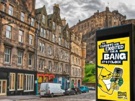 Hooch unveils “no-nonsense” multi-media campaign An image of a street in Edinburgh with Edinburgh Castle in the skyline. The Hooch summer 2026 campaign is on the digital screen in the foreground.