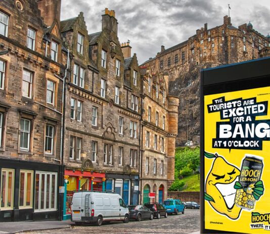 Hooch unveils “no-nonsense” multi-media campaign An image of a street in Edinburgh with Edinburgh Castle in the skyline. The Hooch summer 2026 campaign is on the digital screen in the foreground.