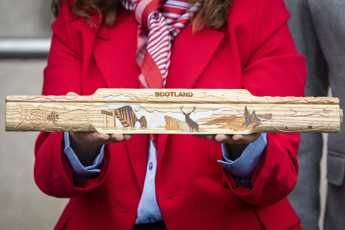 A person holds the King's Relay Baton at the CCEP East Kilbride site.