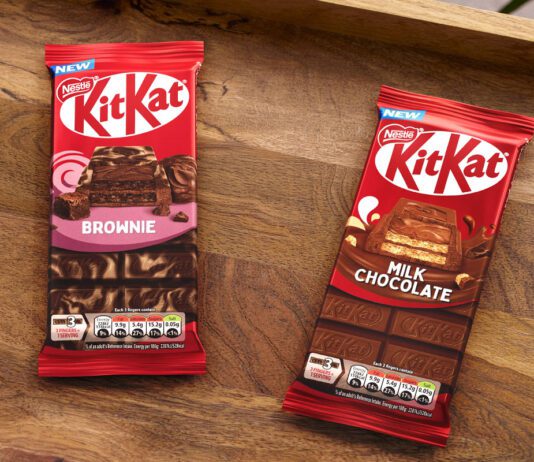 KitKat expands sharing bar range with two new flavours Packs of KitKat Sharing Bars Brownie and Milk Chocolate flavour sit on a wooden tray.