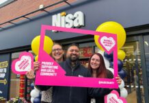 Co-op hits £20million milestone on charity donations A group of people stand outside a Nisa store with a Making a Difference Locally banner around them.