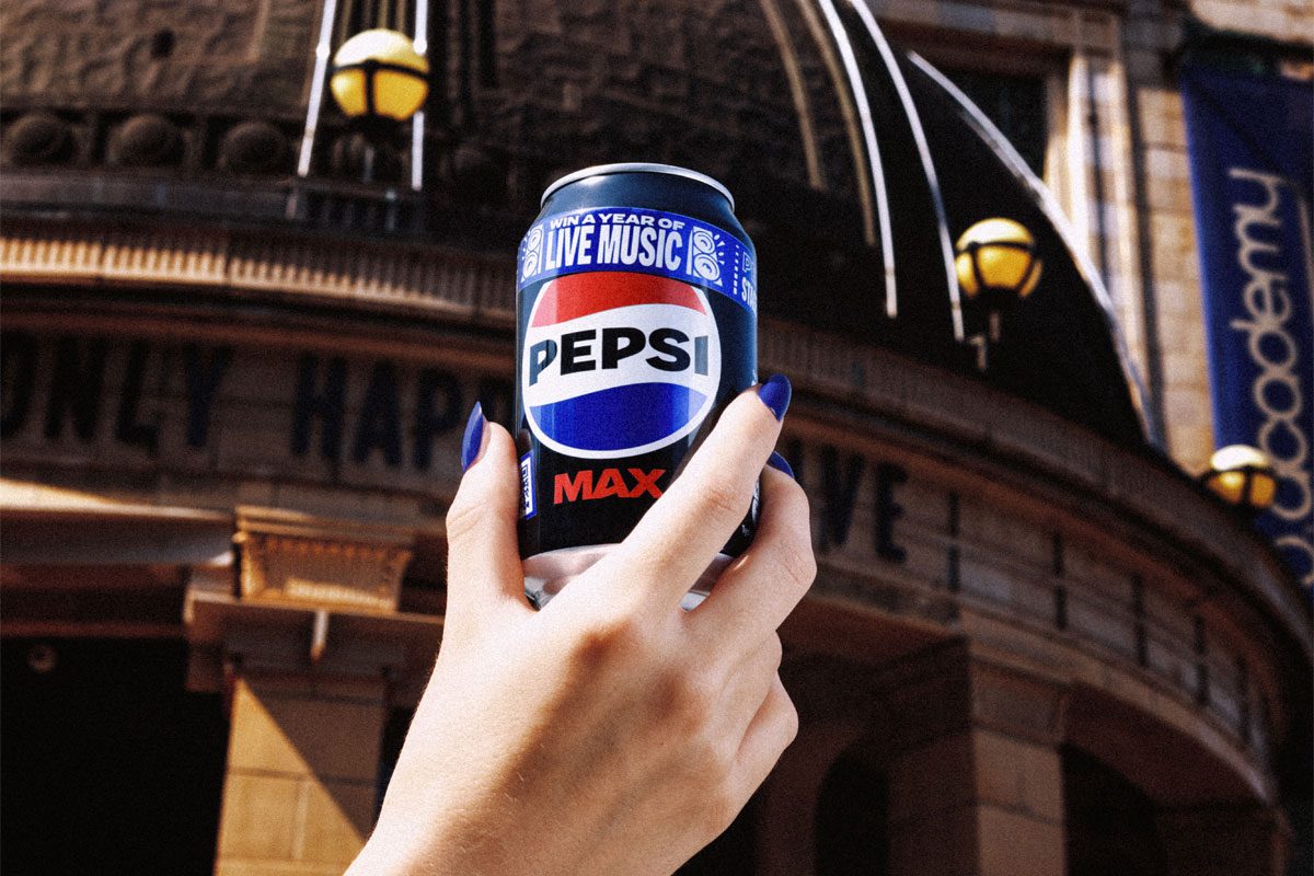 A person holds a can of Pepsi Max in front of the entrance to the O2 Academy.