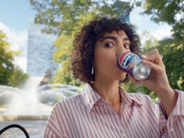 Pepsi launches summer campaign for ice cream flavours A woman sits drinking from a can of Pepsi Cherry & Vanilla Flavour in a park.