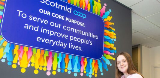 Scotmid marks International Intern Day Anna Lodge, Saltire Scholar, sits with a laptop in Scotmid HQ.