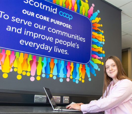 Scotmid marks International Intern Day Anna Lodge, Saltire Scholar, sits with a laptop in Scotmid HQ.