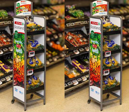 Spar Scotland launches new Healthy Living Programme stands An image of the Spar Scotland Healthy Living Programme dual-branded standing unit with shelves of fruit and veg behind the stands.
