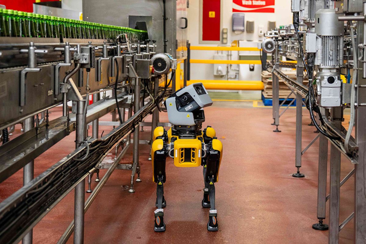 A Boston Dynamics Spot dog walks around the Coca-Cola East Kilbride plant inspecting bottling lines.