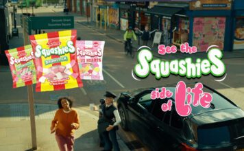 Swizzels pushes Squashies range in new TV ad campaign A still image from the 'See the Squashies side of life' ad campaign for Swizzels with a woman walking down a street with inflatable characters near her. Packs of Swizzels Squashies variants are also included in the imagery.