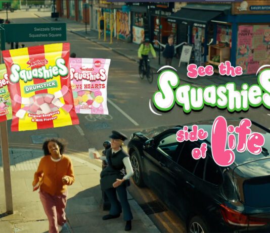 Swizzels pushes Squashies range in new TV ad campaign A still image from the 'See the Squashies side of life' ad campaign for Swizzels with a woman walking down a street with inflatable characters near her. Packs of Swizzels Squashies variants are also included in the imagery.