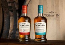 Tomatin expands listings across Booker locations Bottles of Tomatin 10 Year Old whisky and Tomatin Double Cask whisky stand in front of a wooden barrel with the Tomatin logo on it.