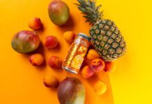 Vault City ramps up sour beer production for anniversary A can of Vault City 999GL sits among different fruit against an orange and yellow background.
