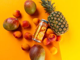 Vault City ramps up sour beer production for anniversary A can of Vault City 999GL sits among different fruit against an orange and yellow background.