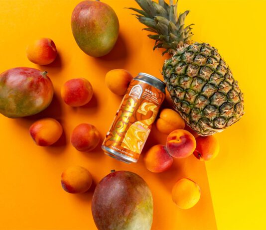 Vault City ramps up sour beer production for anniversary A can of Vault City 999GL sits among different fruit against an orange and yellow background.