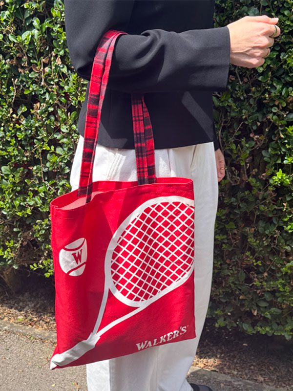 A person hangs the Walker's Perfect Serve Hamper Tote Bag from their elbow.