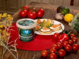Yester Farm scoops up 3-star Great Taste Award A tub of Yester Farm Dairies Soft Cheese sits next to a plate with canapés on it and different foods around the plate.